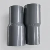 Dua buah socket PVC Pralon ukuran 1 inch x 3/4 inch berwarna abu-abu di Toko Bangunan Sinar Karya Pontianak